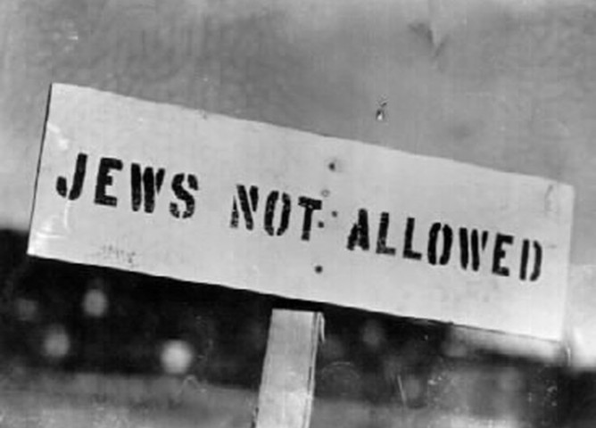 A wooden sign with the words: Jews Not Allowed.